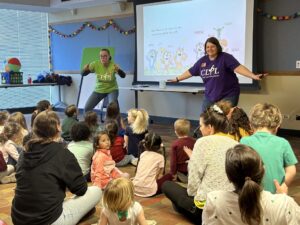 Two CLPL librarians lead interactive story during a school field trip to the library